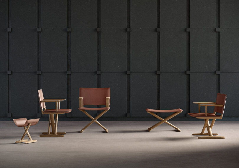 Five wooden chairs with brown seats and one matching bag holder arranged in a spacious room with a dark, textured wall background