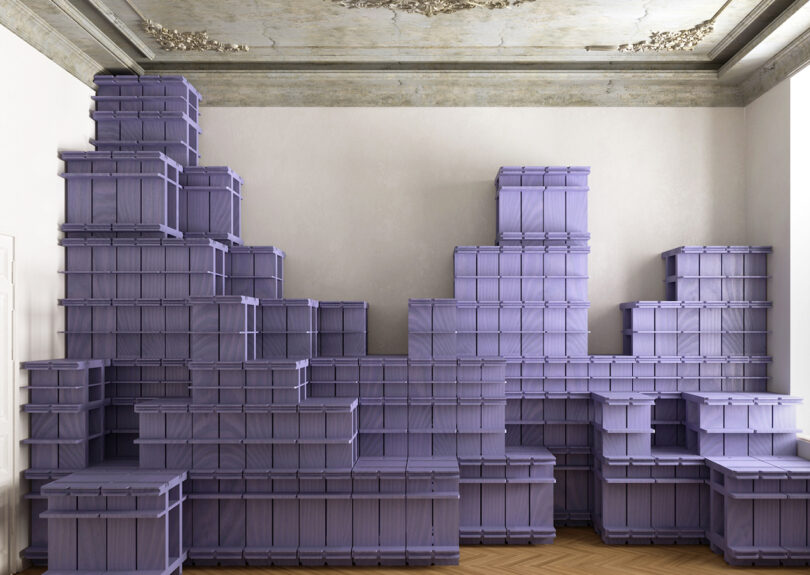 Stacks of purple storage crates are arranged against a white wall in a room with a decorative, partially cracked ceiling and patterned wooden floor