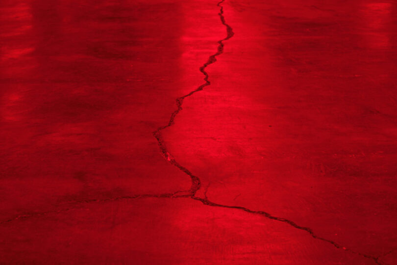 Crack in concrete floor under red light